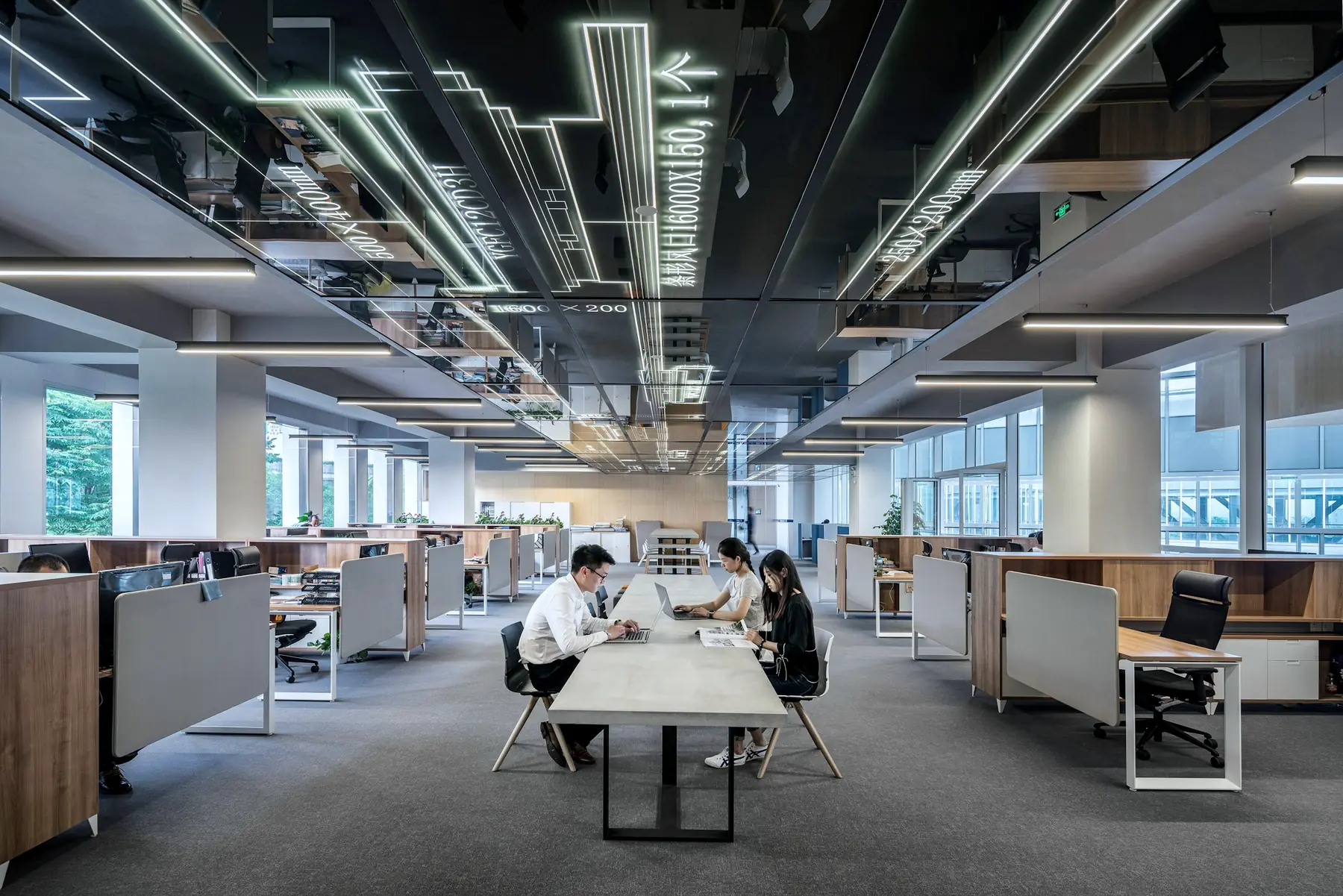 A bright open-plan technology office with long rows of desks