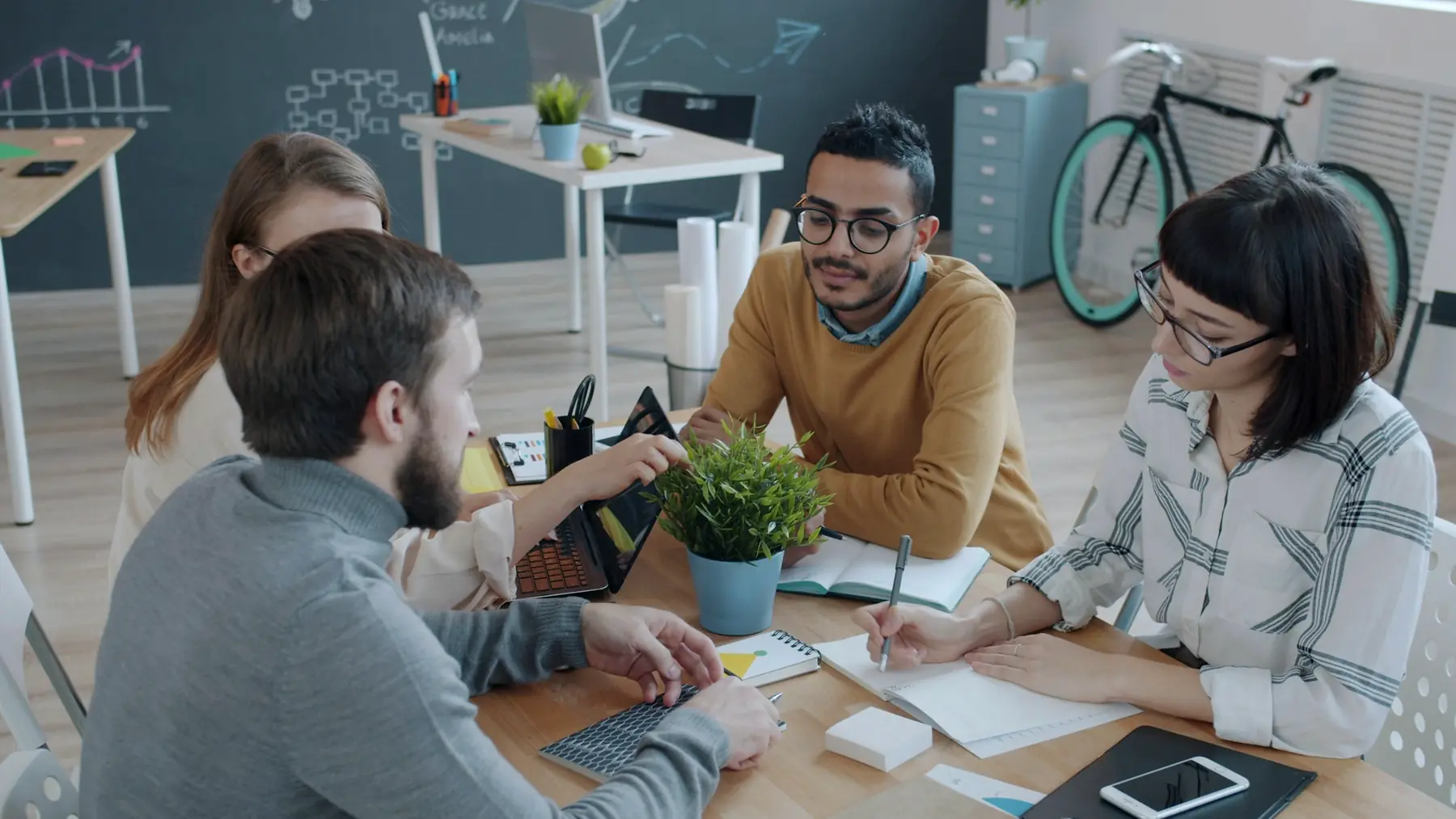 A small team talking work through around a table
