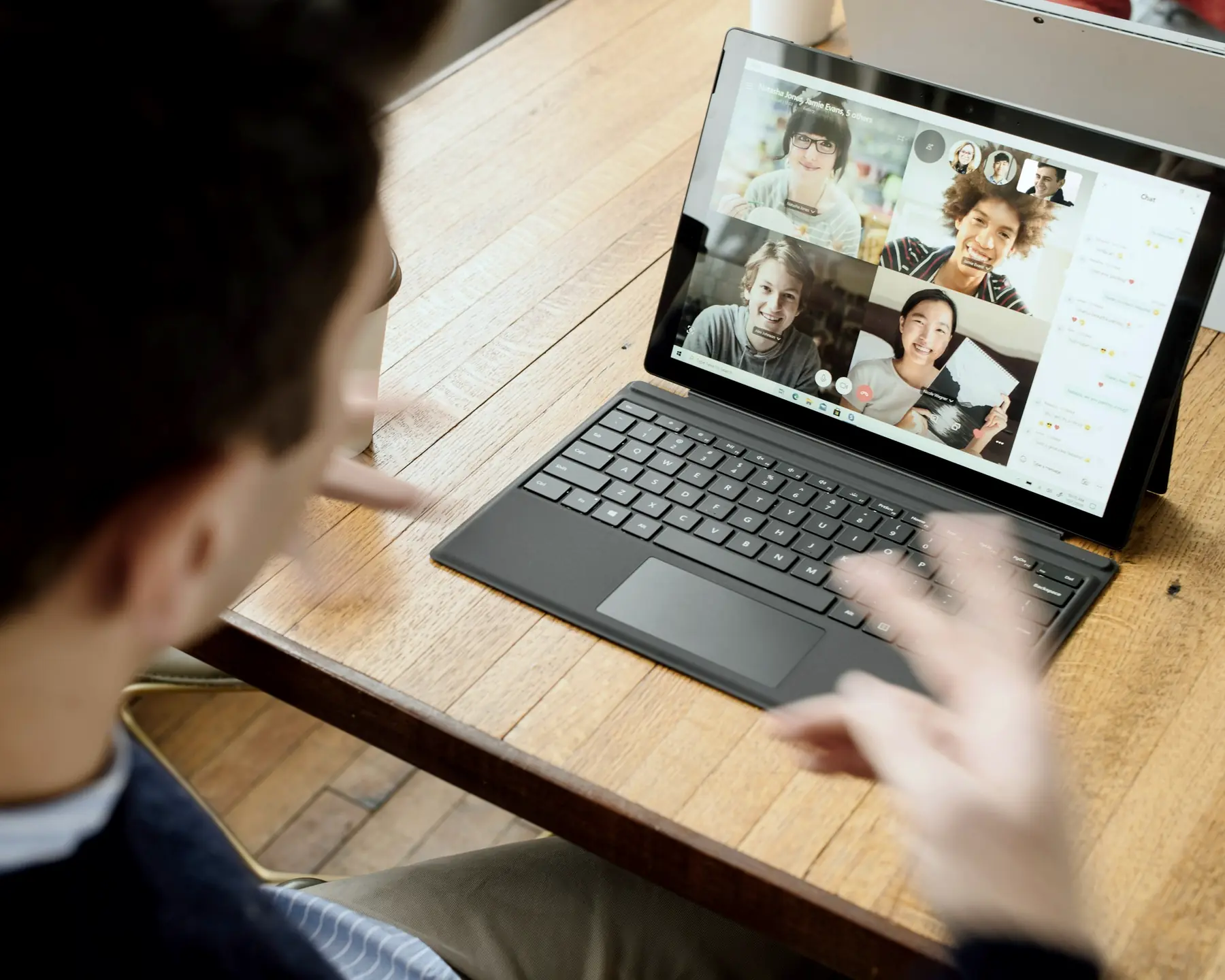A distributed team on a video call, seen on a laptop screen